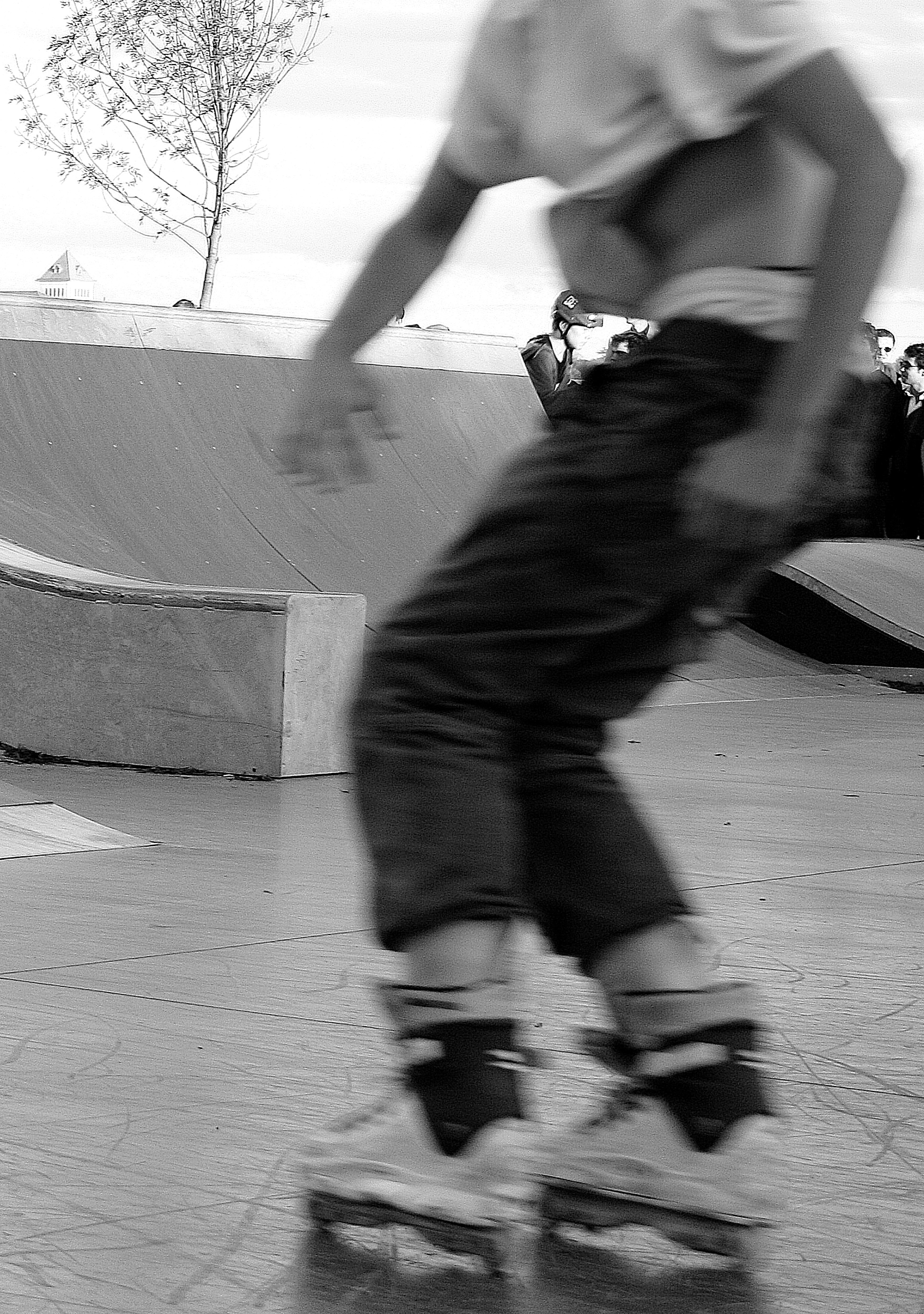 A rollerblader skating at a skate park.
