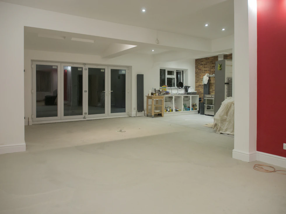 Open renovated residential living room with broad doors and updated interior finishes