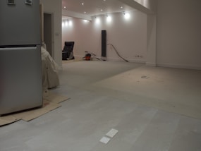 A large, empty room with some appliances.