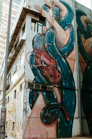 A dragon and serpent mural on a building.