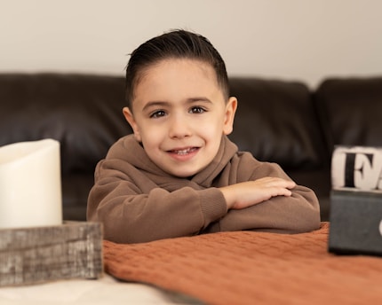 A smiling young boy poses for a photo.