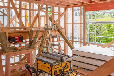 Construction site showing wood framework and tools.