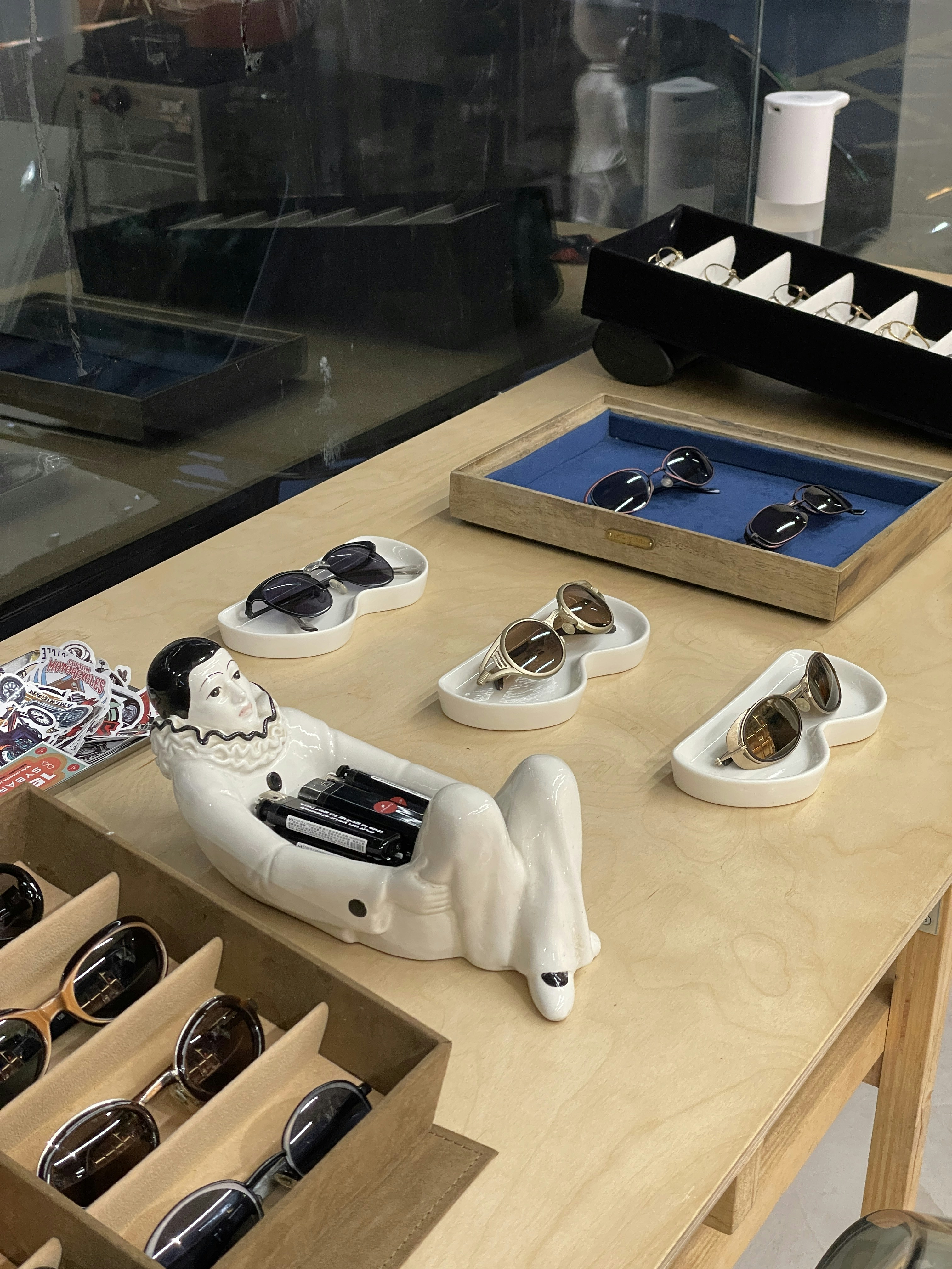 Sunglasses are displayed on a counter in a shop.