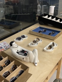 Sunglasses are displayed on a counter in a shop.