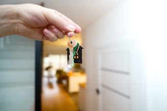 Holding house keys in front of the entrance.