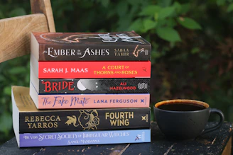 Books and coffee sit together on a chair.