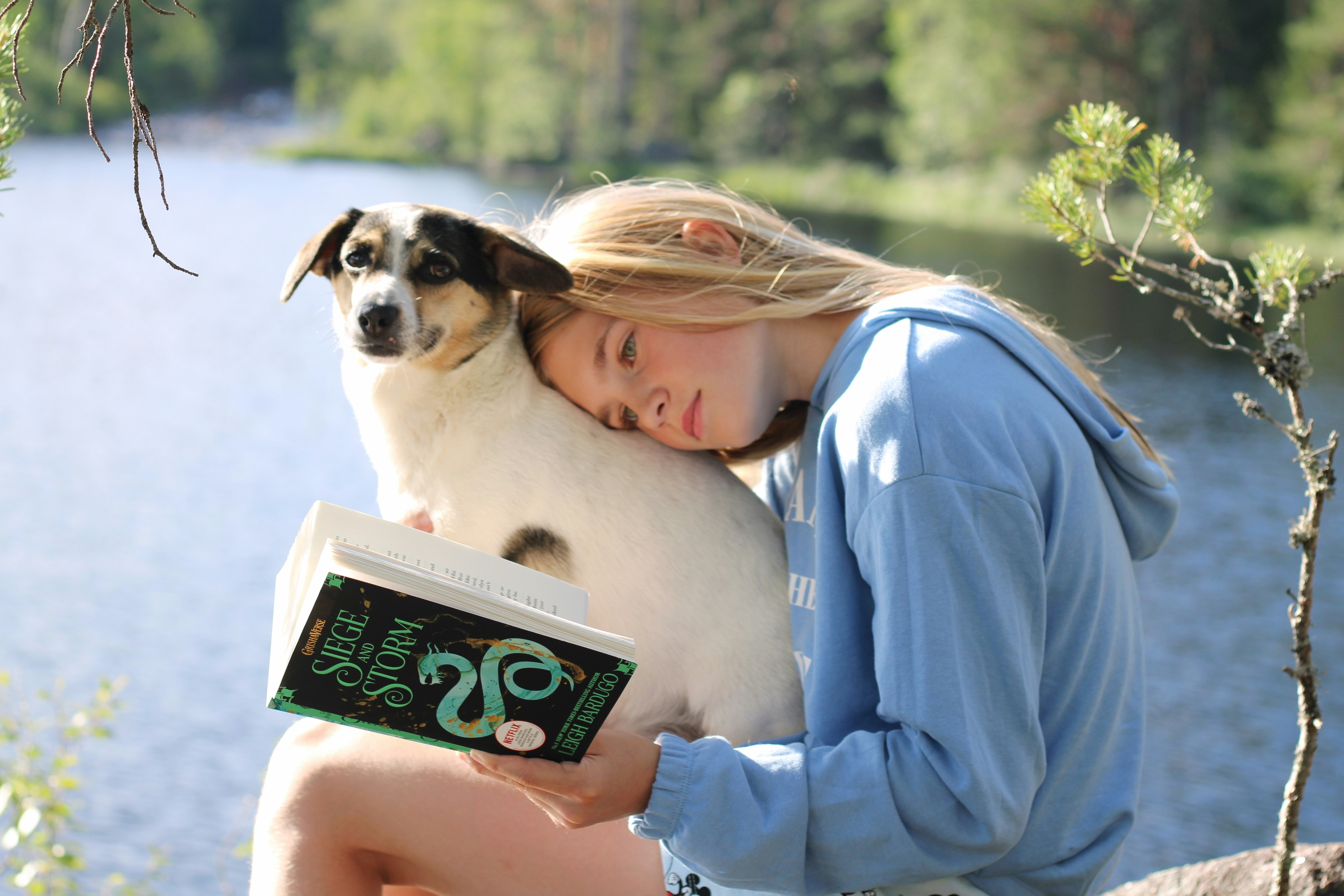 A girl and a dog are reading