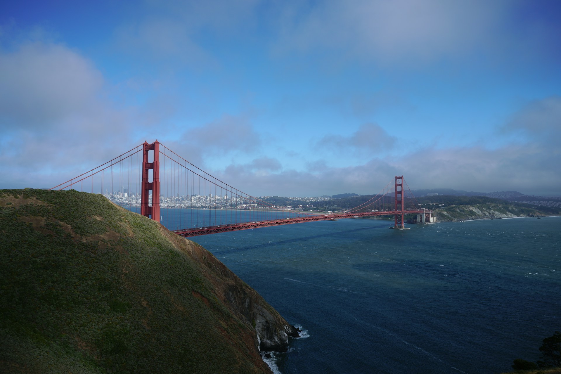The golden gate bridge spans across the water.