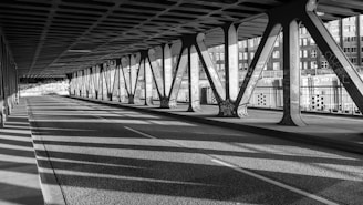 Underneath a bridge, shadows are cast.