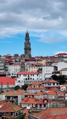 A tower overlooking a city with red roofs.