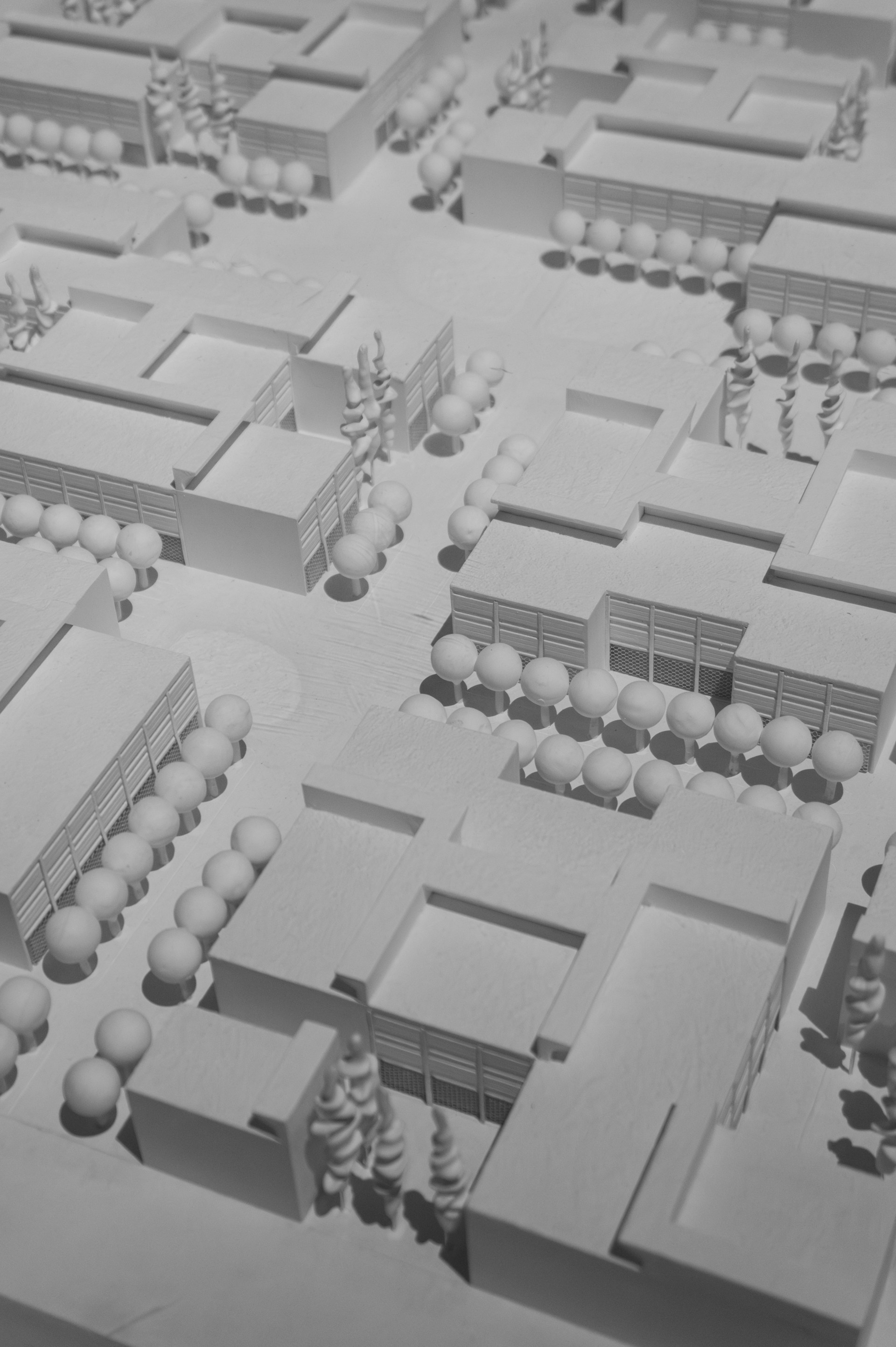 Architectural model of a city plan displayed in white.