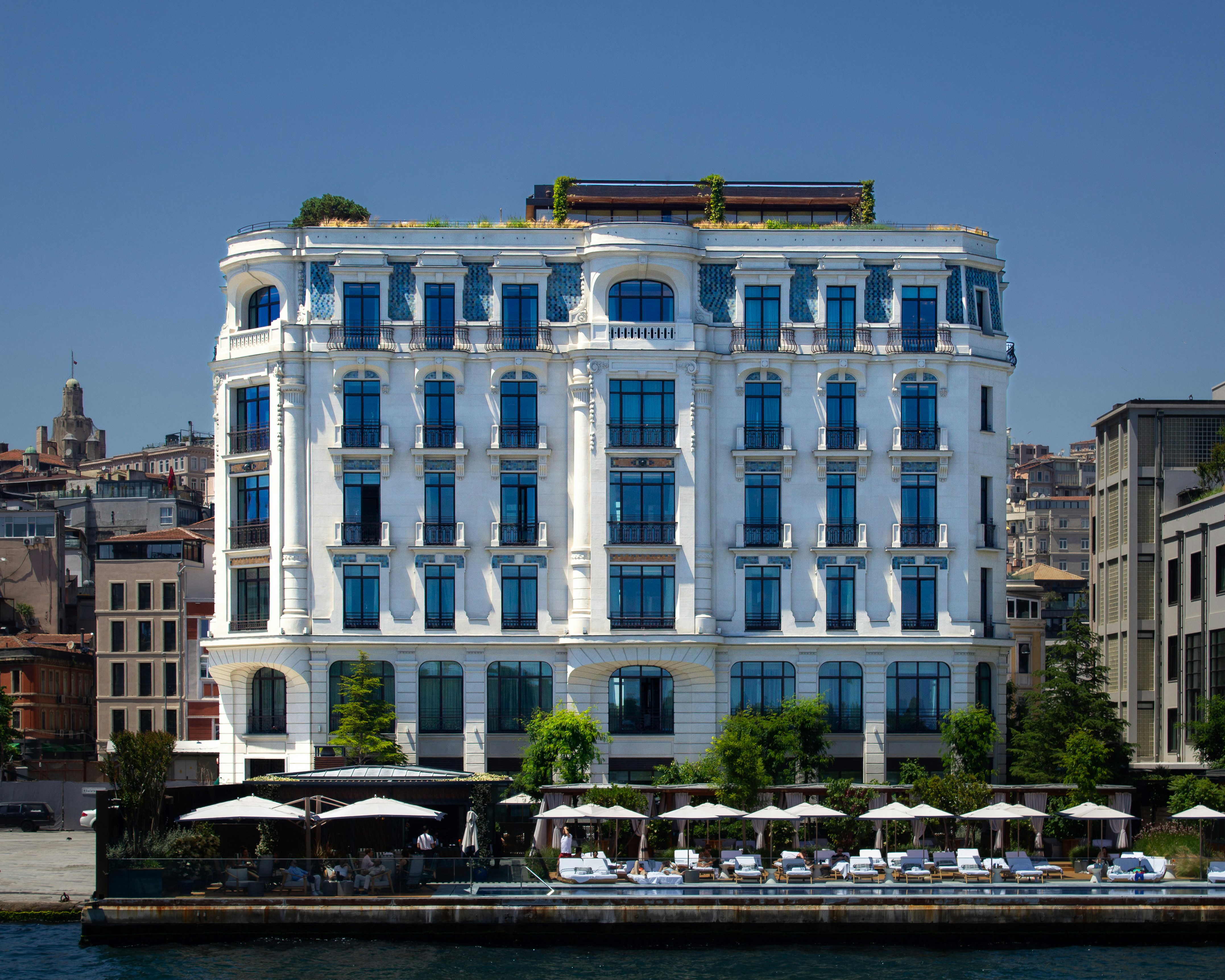 A luxurious hotel building sits by the water.