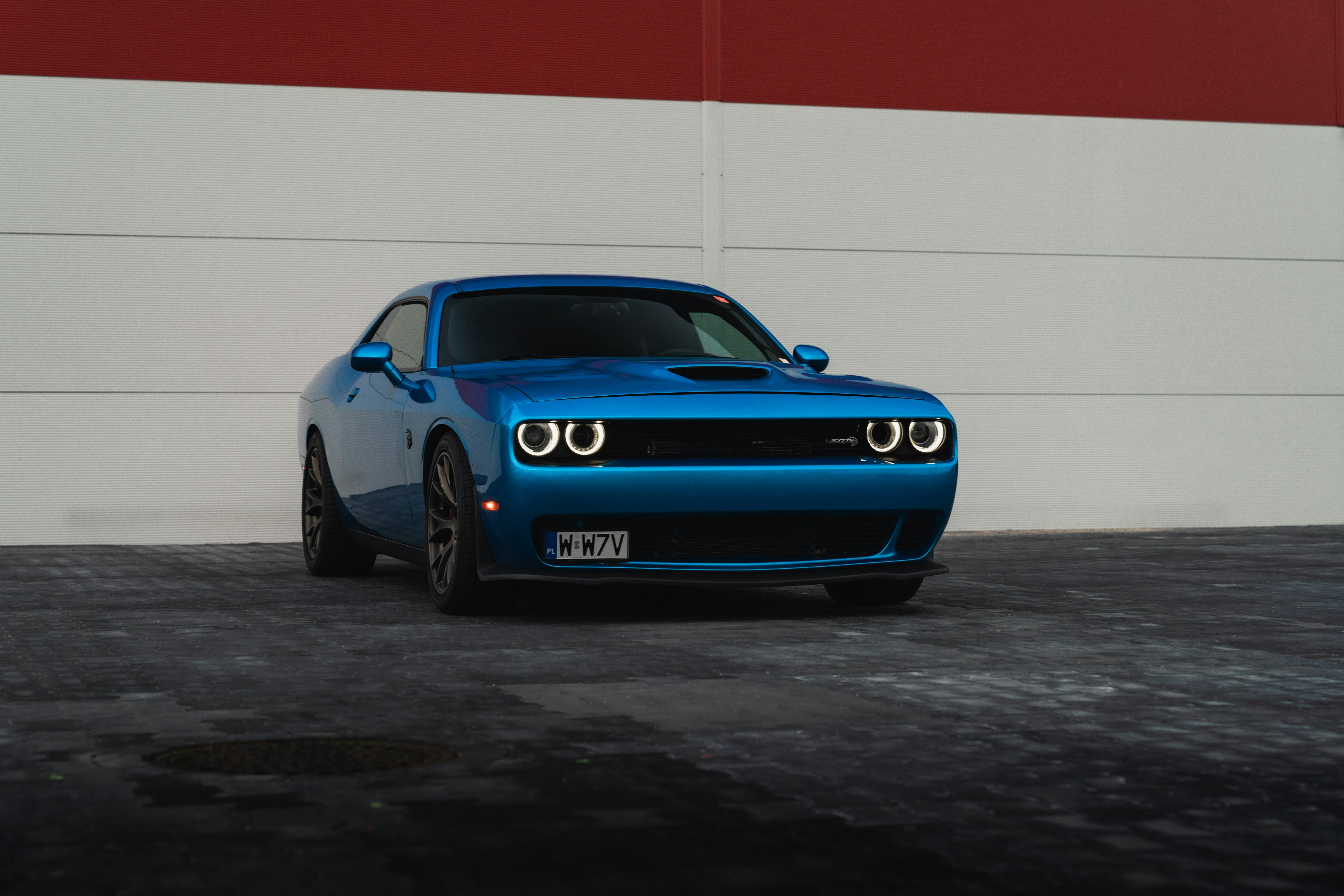 A blue dodge challenger is parked.