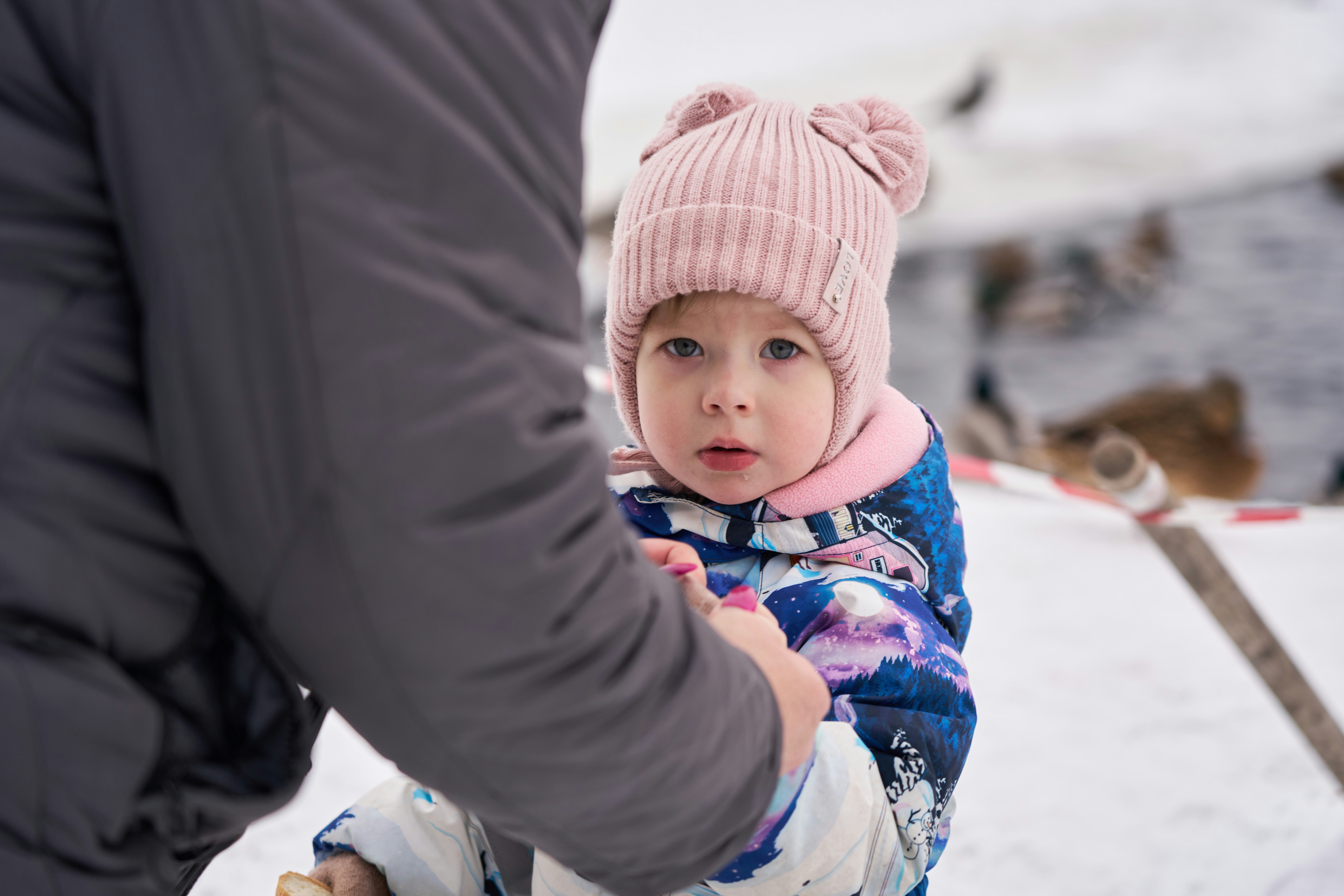 A young girl looks curious in winter.