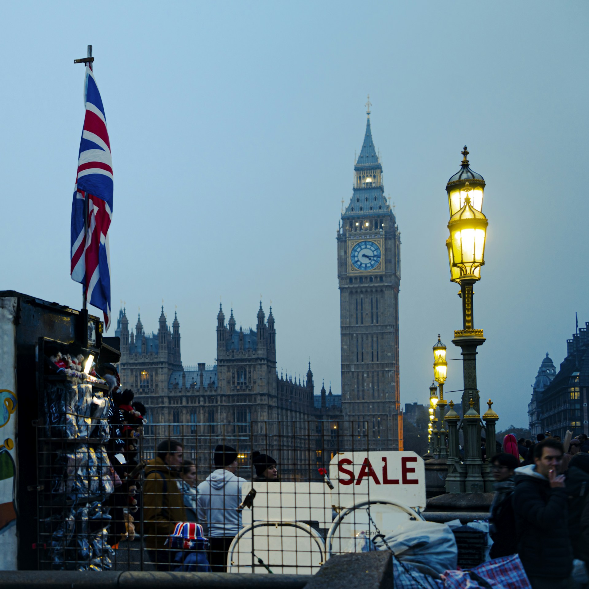 Big ben looms over a bustling london street scene.