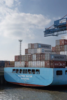 A maersk ship loaded with cargo containers.
