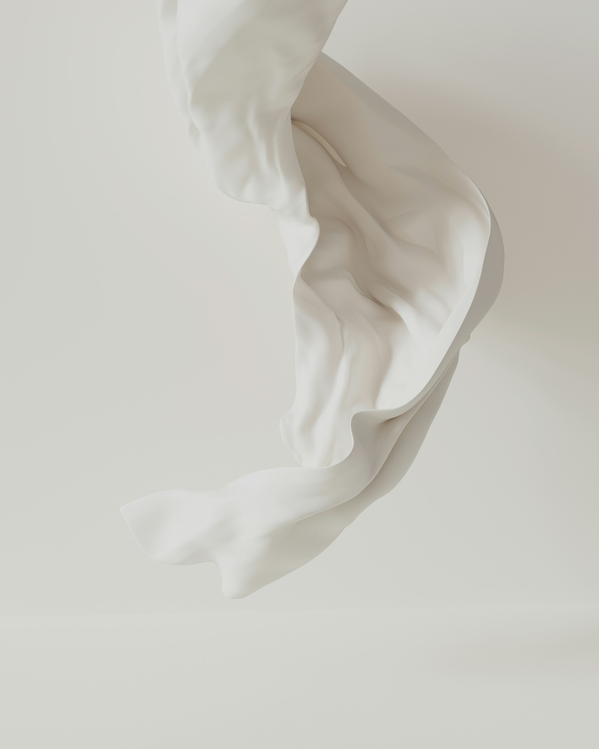 A flowing white cloth against a white backdrop.