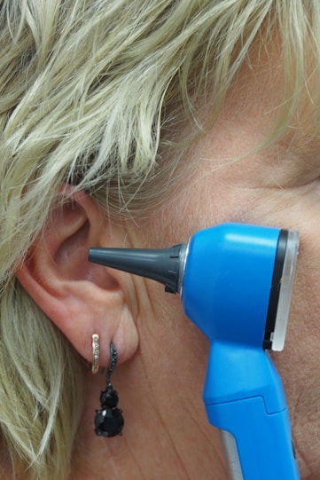 A doctor is using an otoscope to check ear.