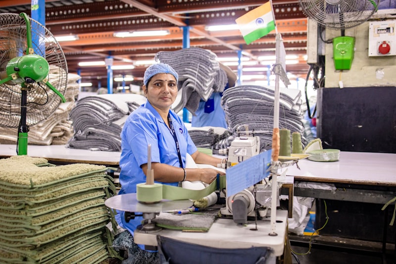 Indian woman factory worker at sewing machine in manufacturing unit