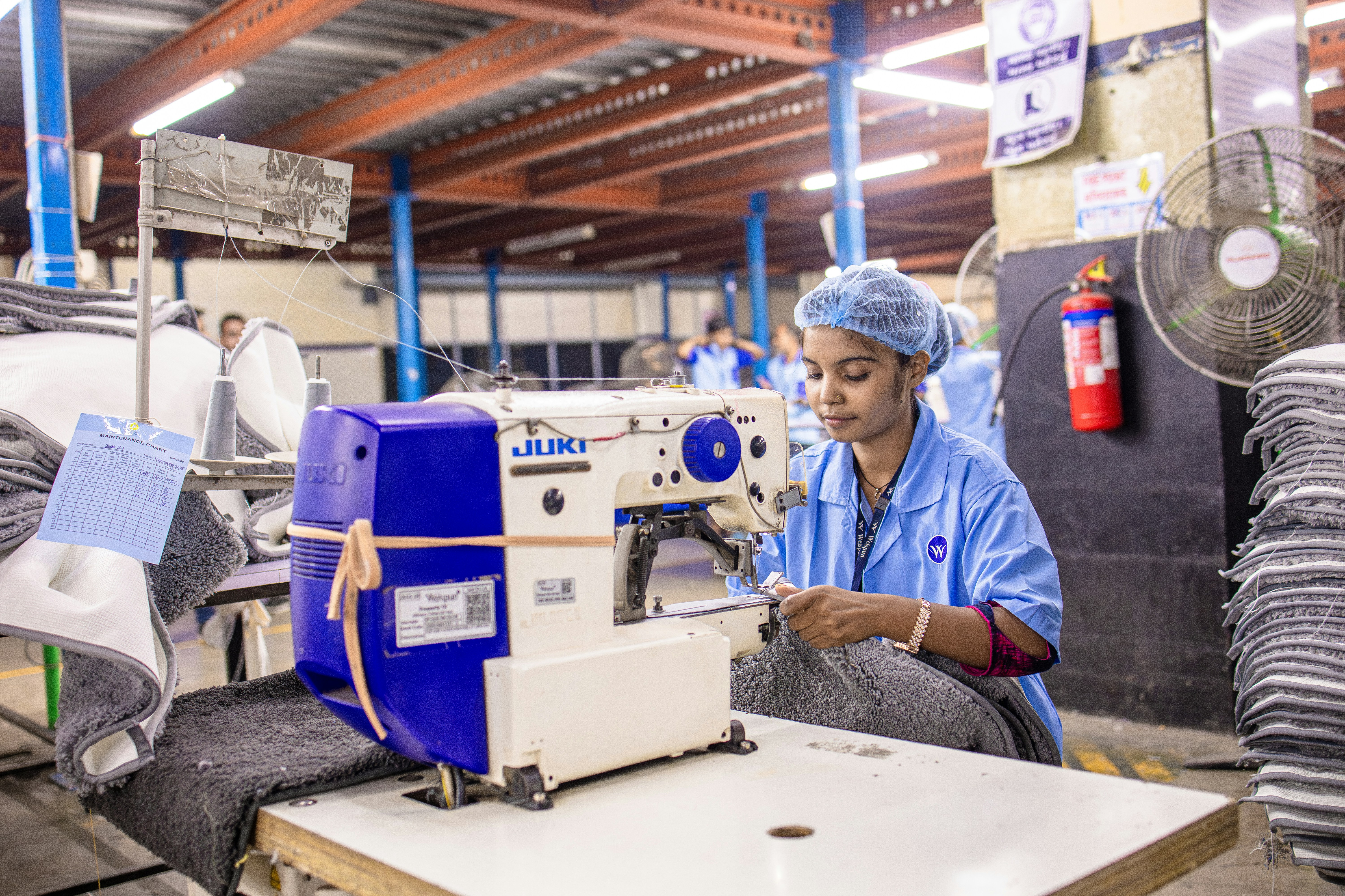Woman sews clothes in a factory.