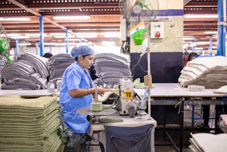 A factory worker operates a machine.