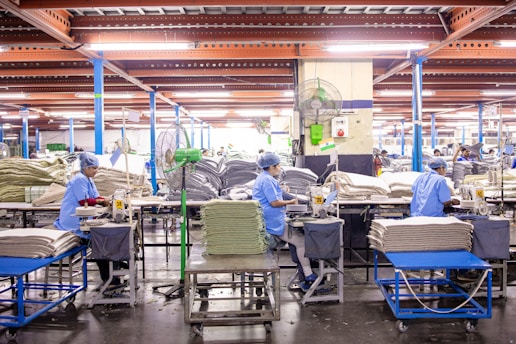 Workers are in an industrial textile manufacturing facility.