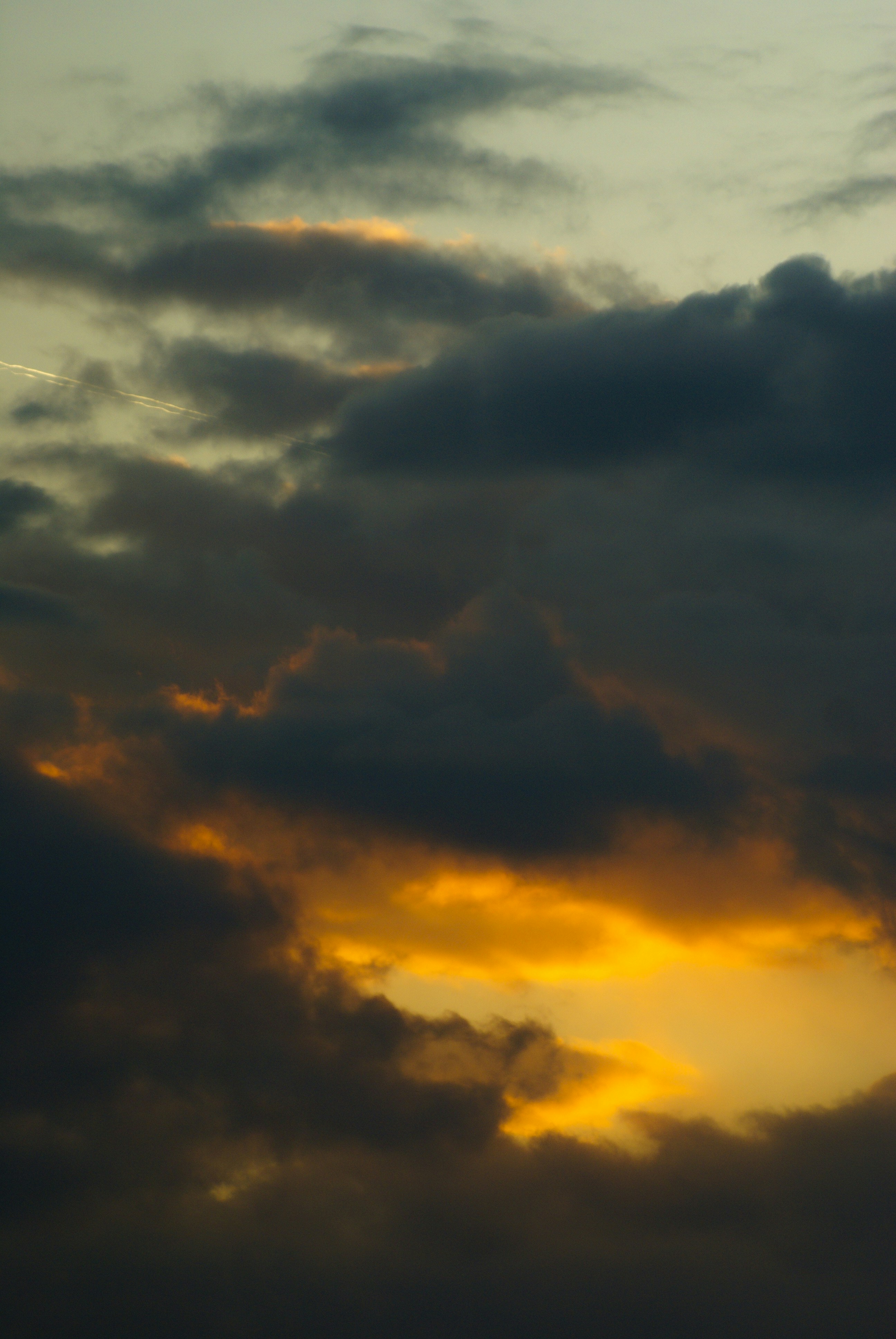 Dramatic clouds illuminated by a golden sunset.