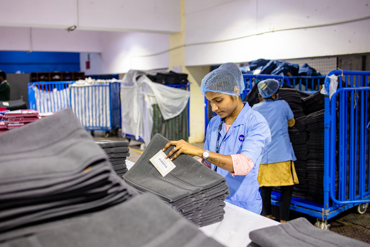 Factory workers are folding and packing towels