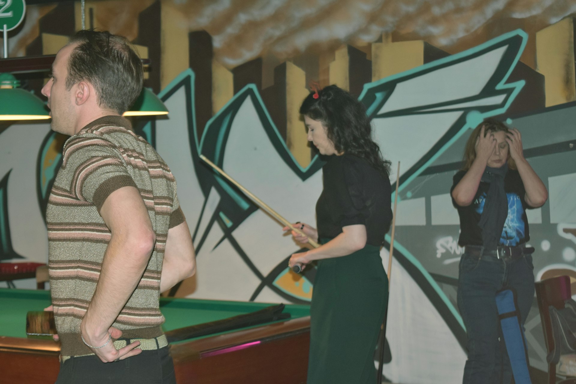 Friendly atmosphere with people playing billiards in a bar