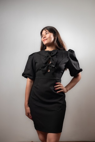 Woman poses in a black dress.