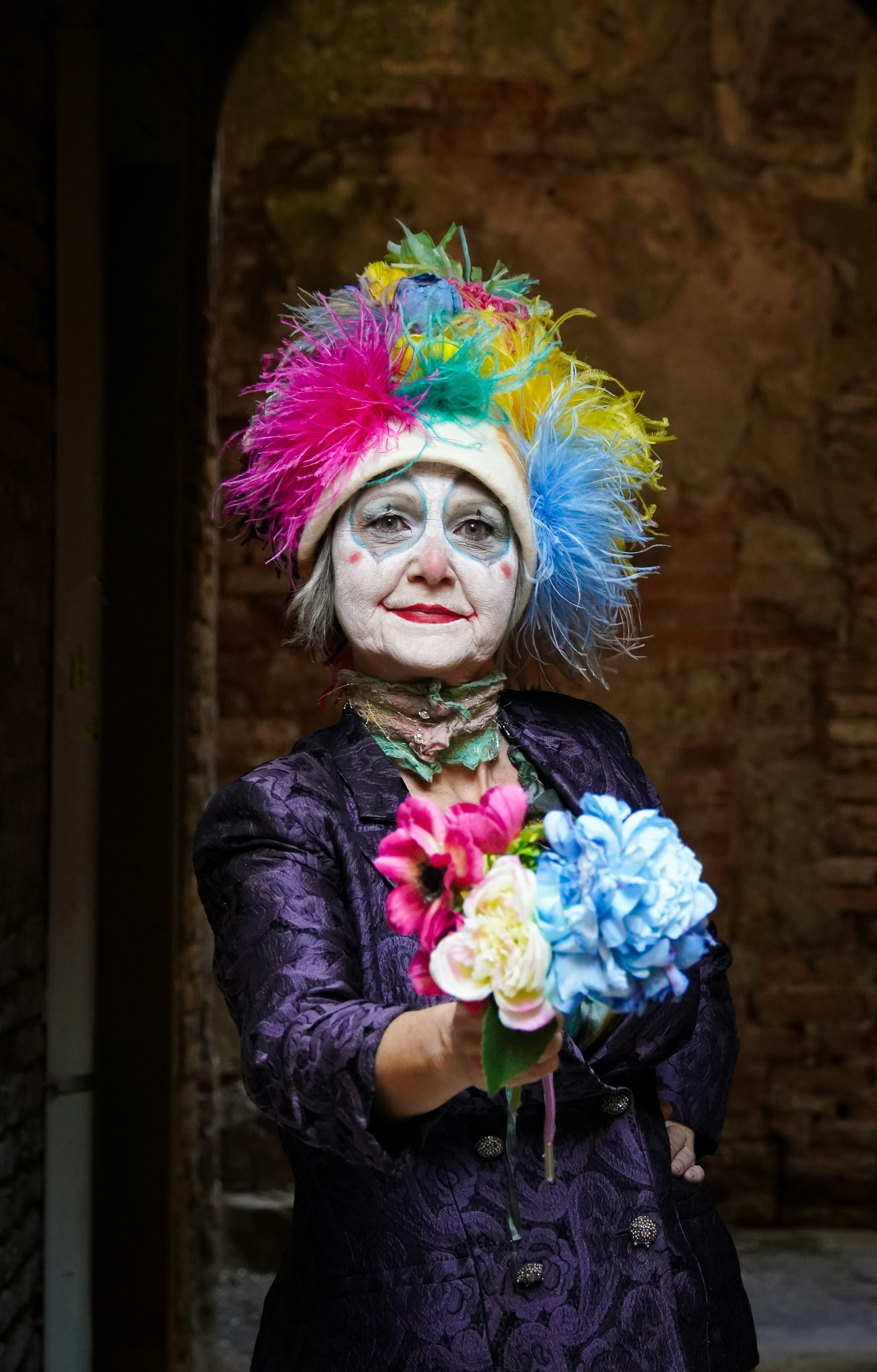 Clown with flowers poses for the camera.