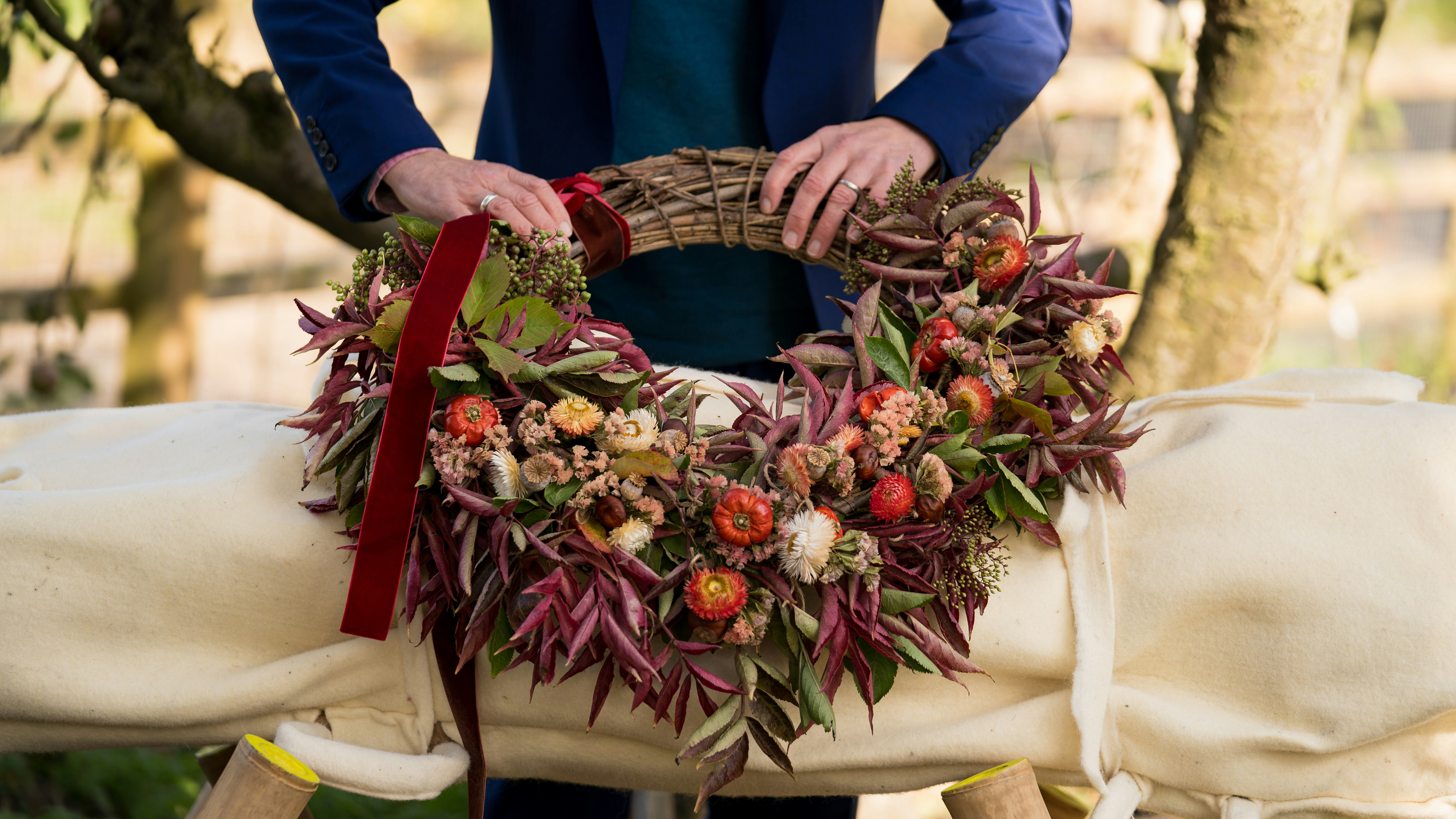 Someone is making a beautiful floral wreath.