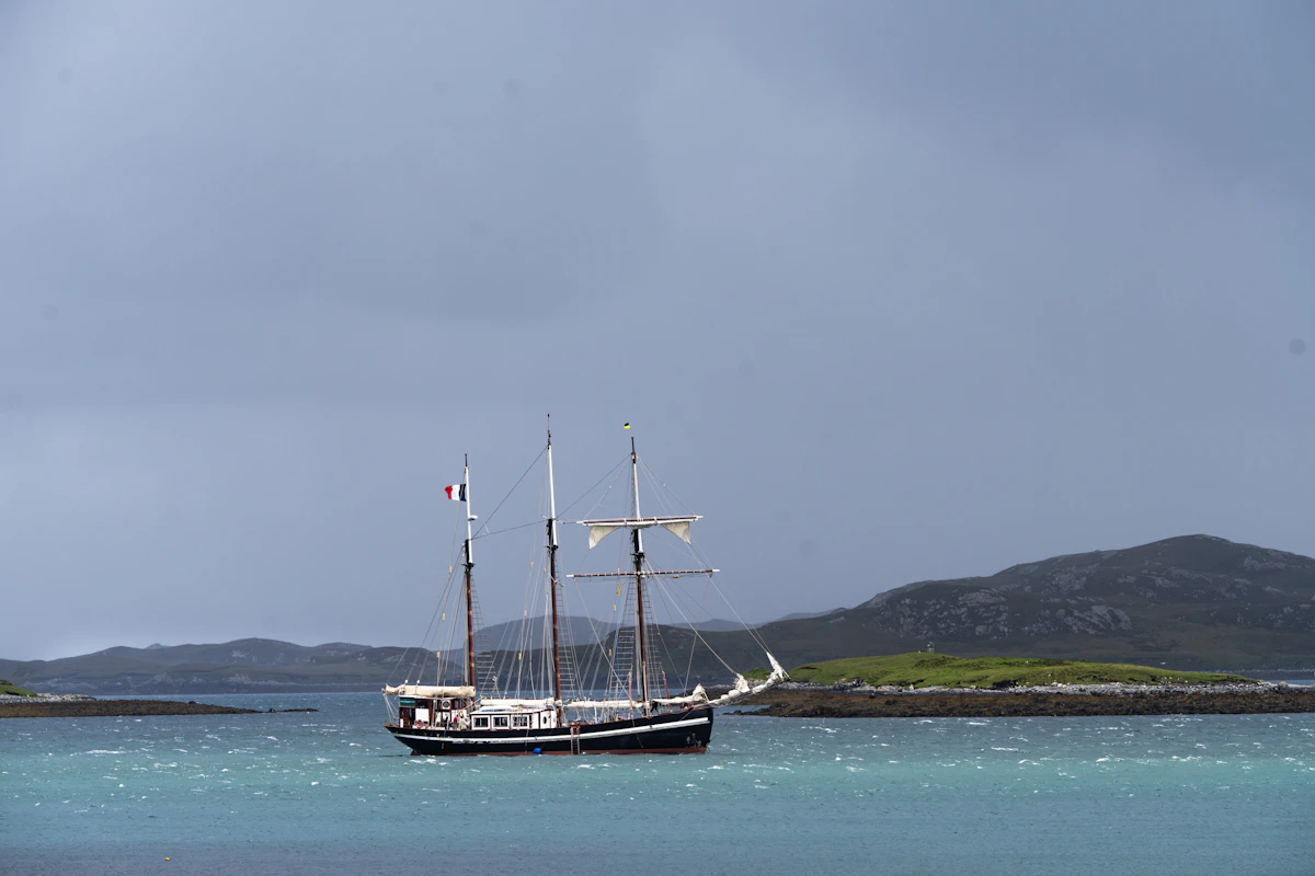 A motor yacht cruising along a sheltered coast