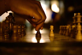 A hand makes a chess move on the board.