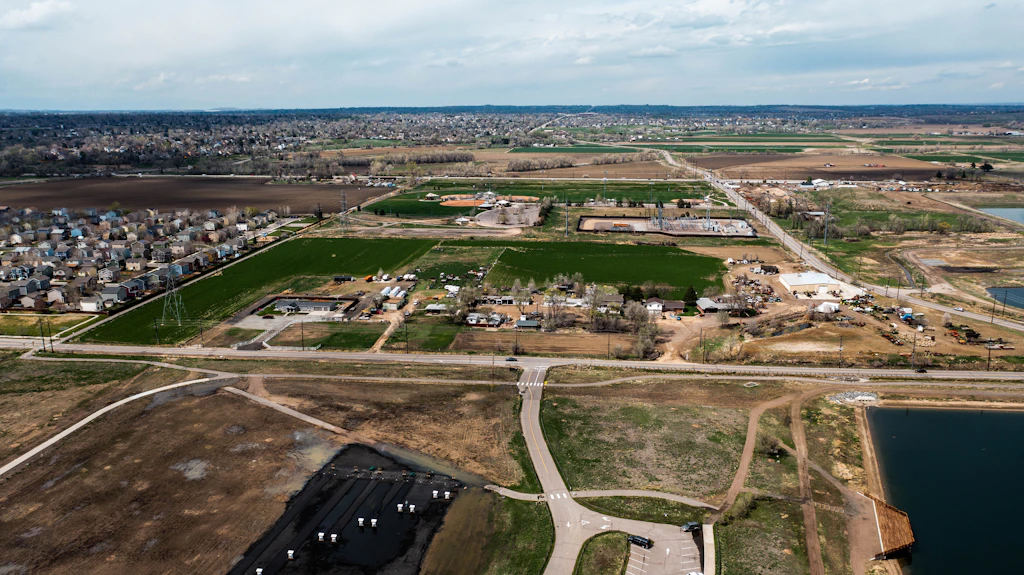 Aerial view of suburban development meeting open farmland