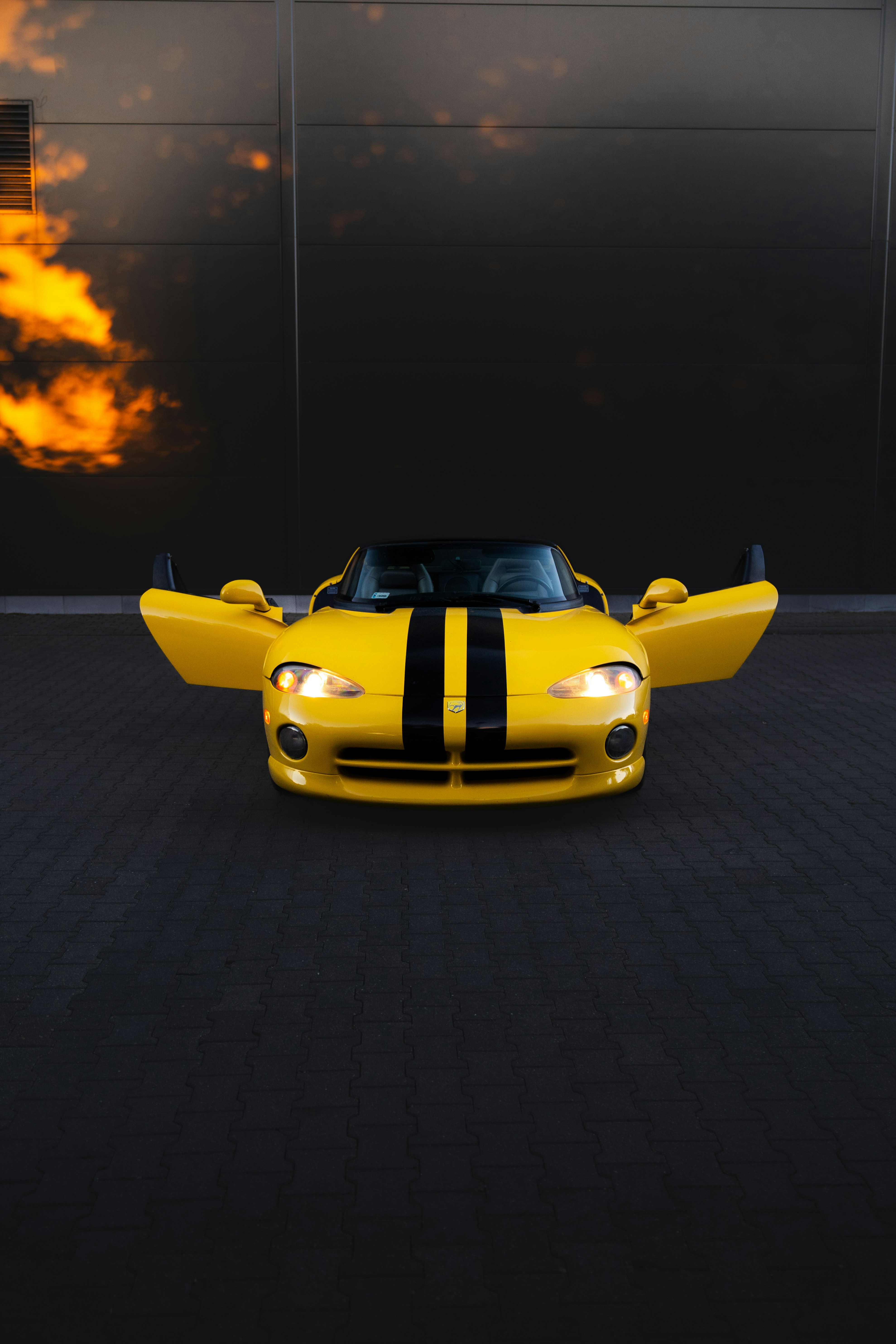 A yellow viper with doors open is ready.