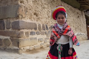 A young girl in traditional peruvian clothing.