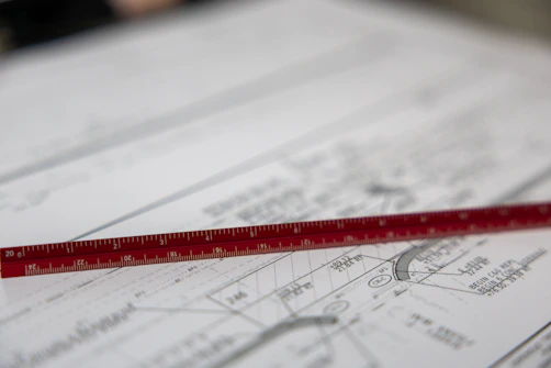 A ruler sits on blueprints.