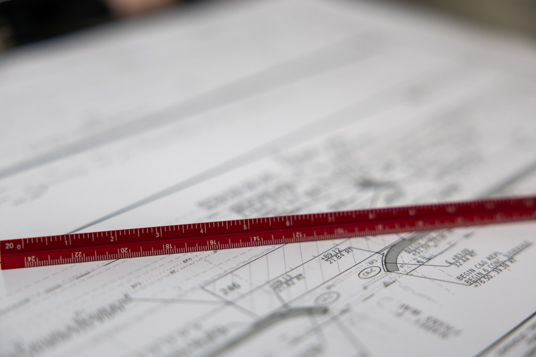 A ruler sits on blueprints.,