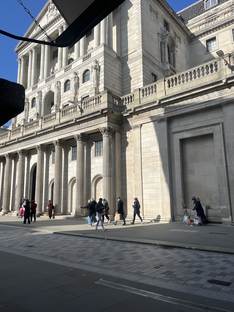 People walk in front of the Bank of England building in London