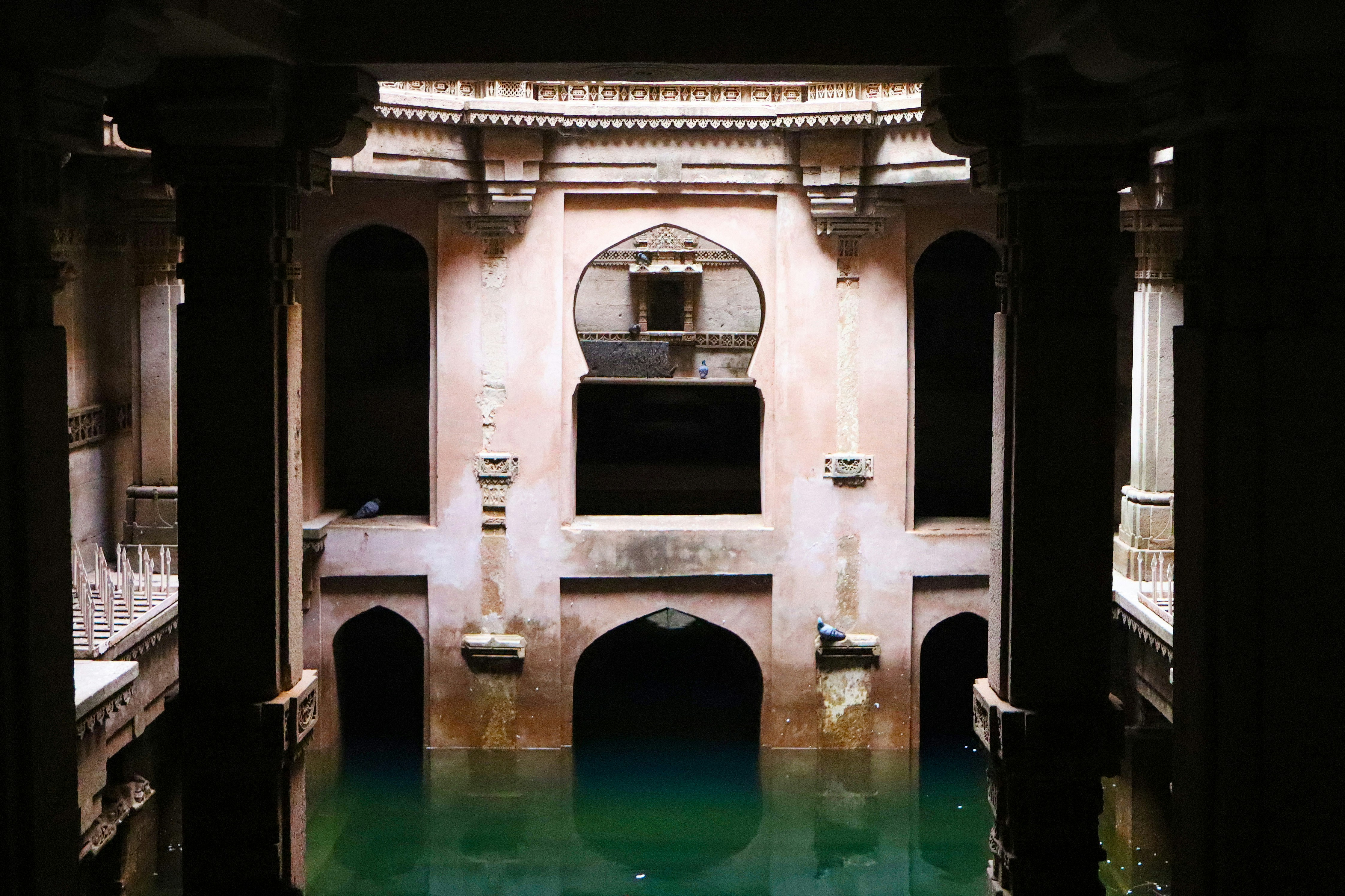 This is a stepwell filled with turquoise water.