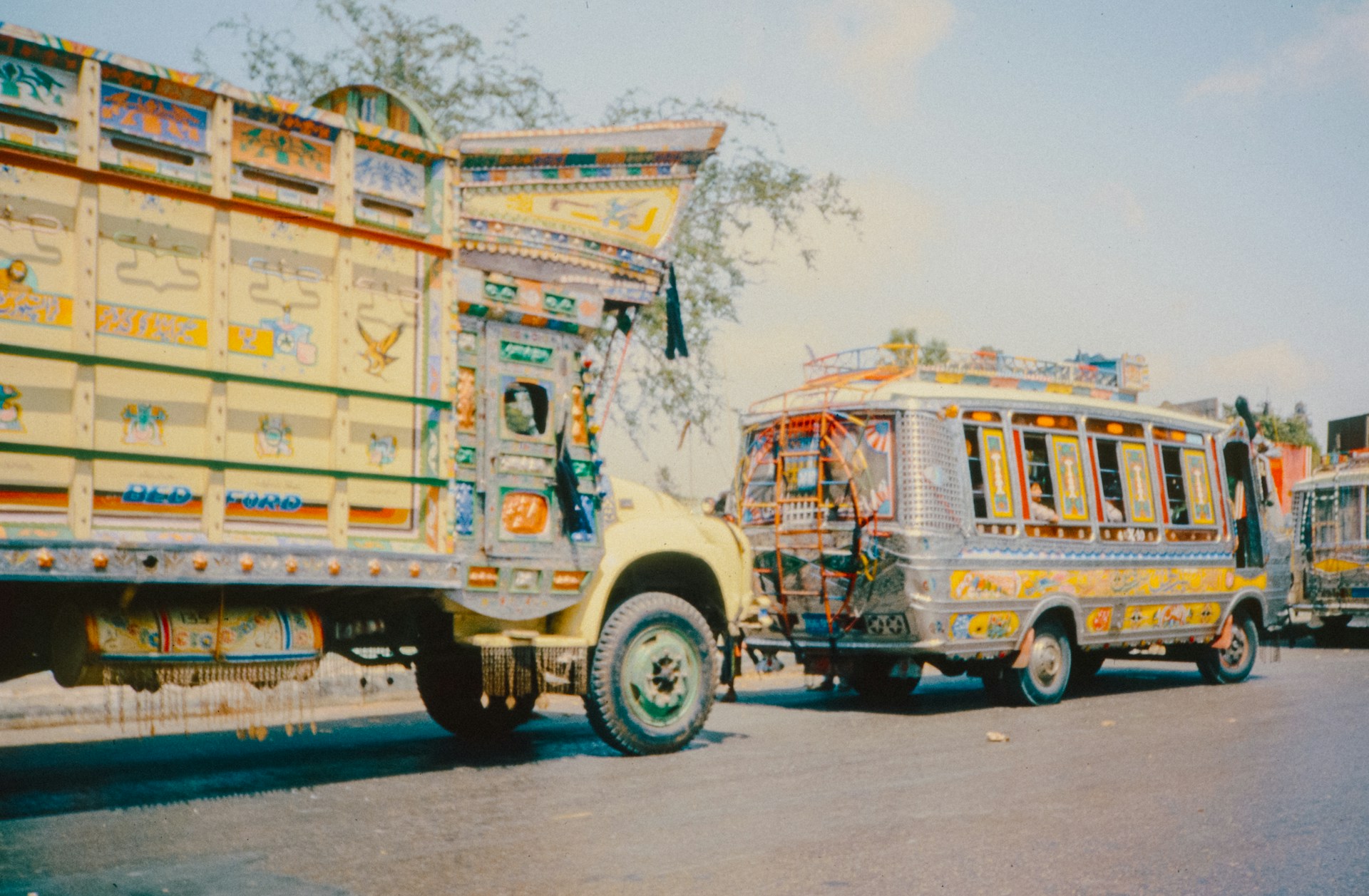 Colorful, decorated trucks on a street.