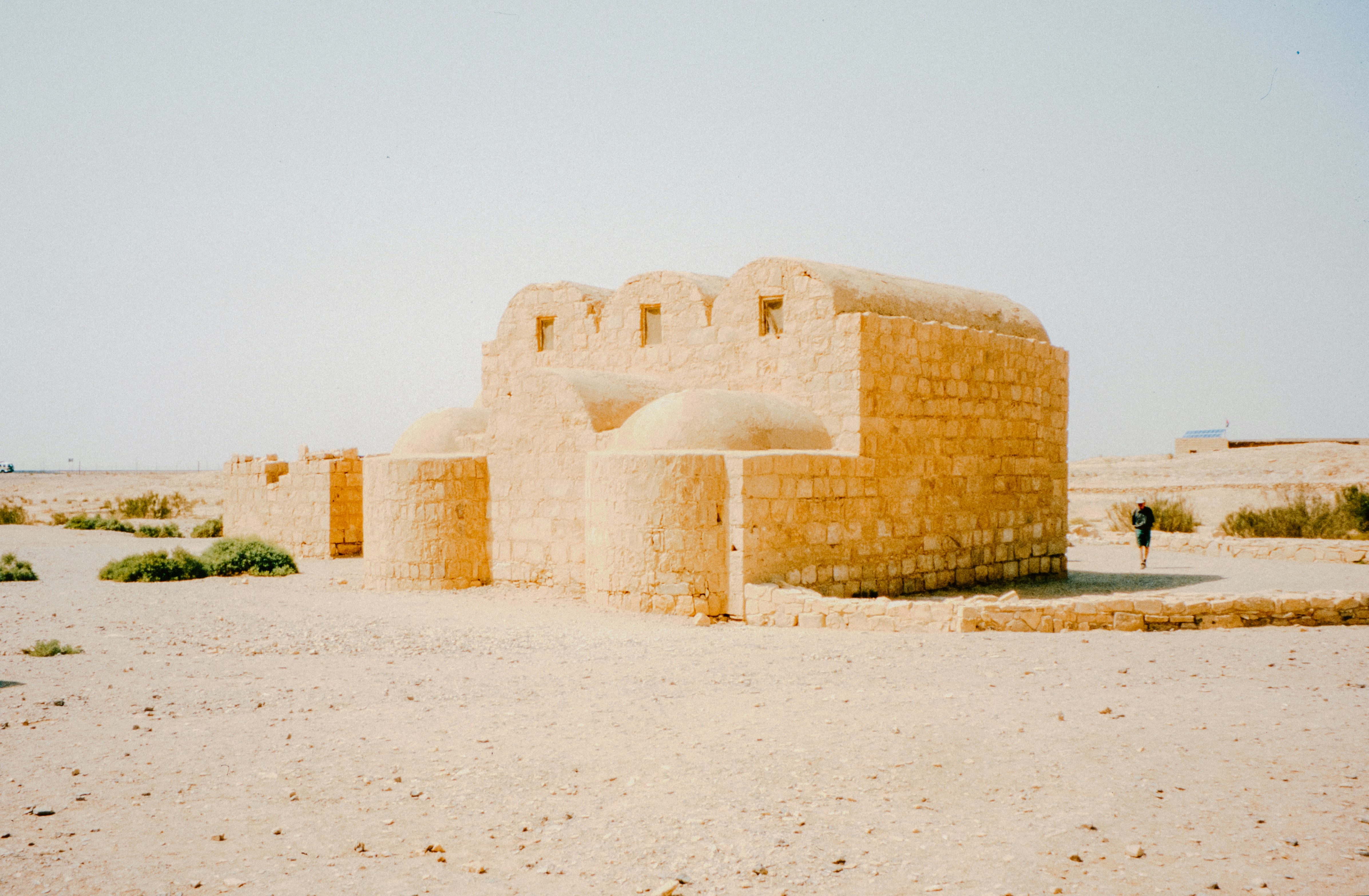 Ancient ruins sit in a desert landscape.