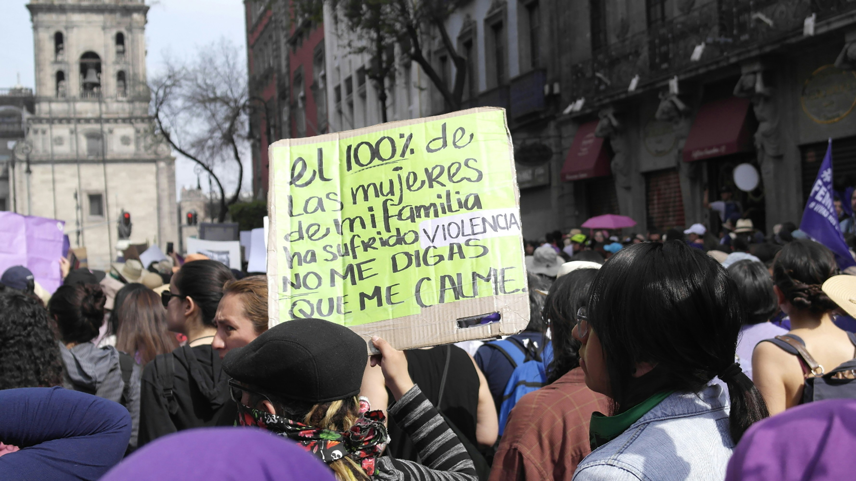 Protesters march with signs about women's rights.