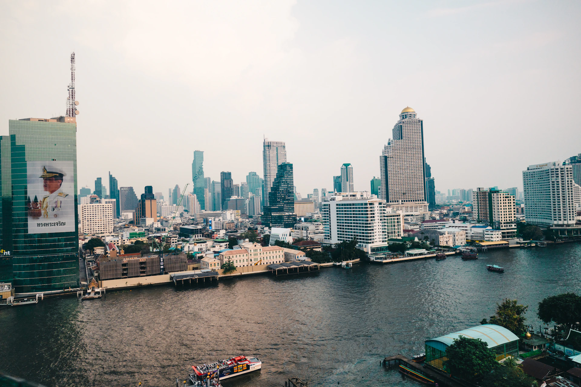 Bangkok cityscape next to a large river.