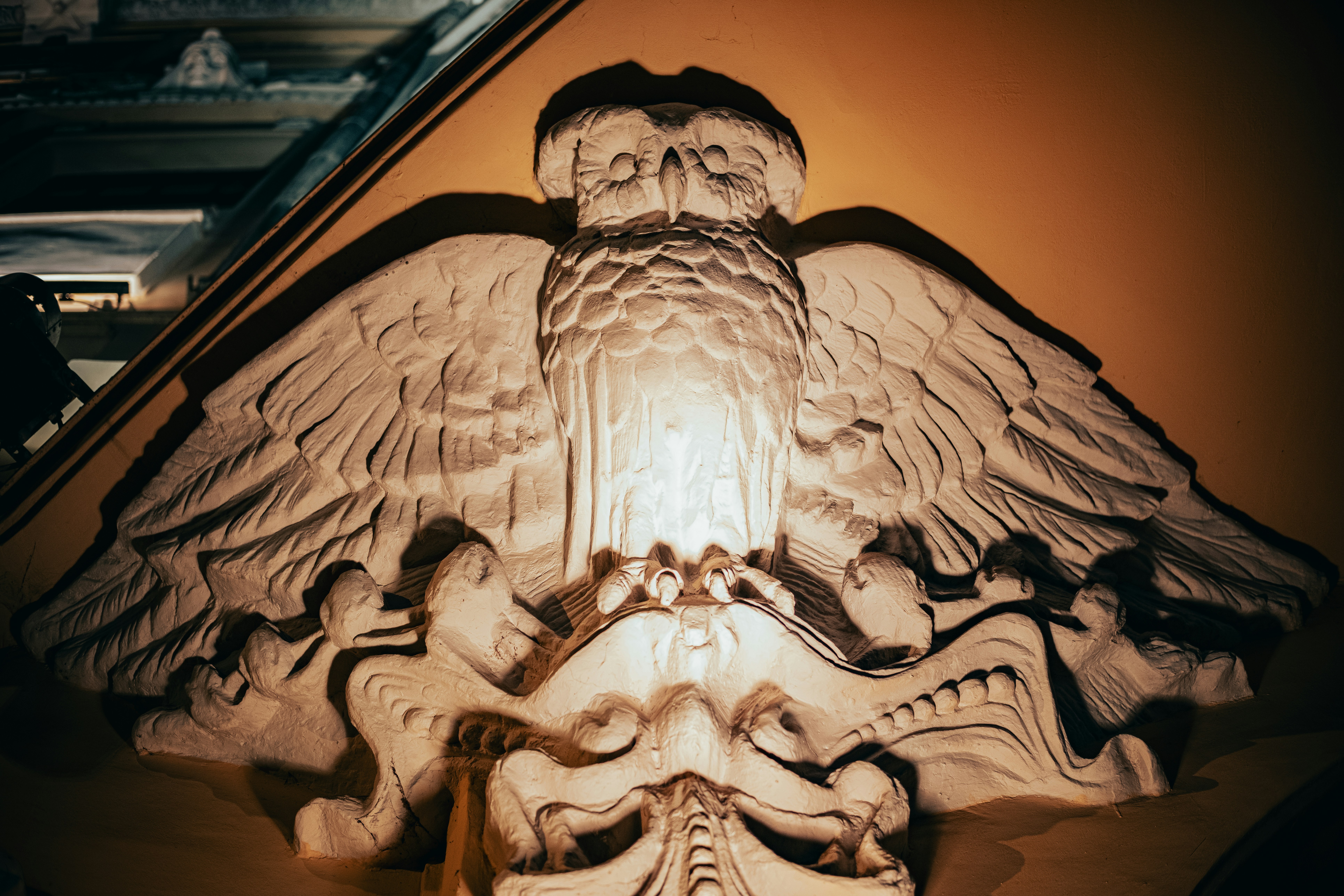 A stone carving of an owl is displayed.