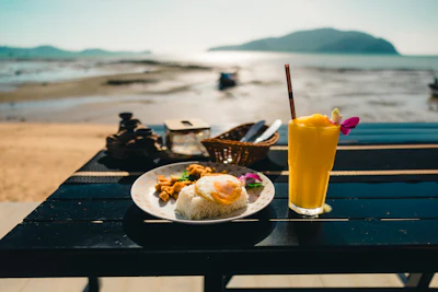 A casual meal and drink enjoyed with a beach view