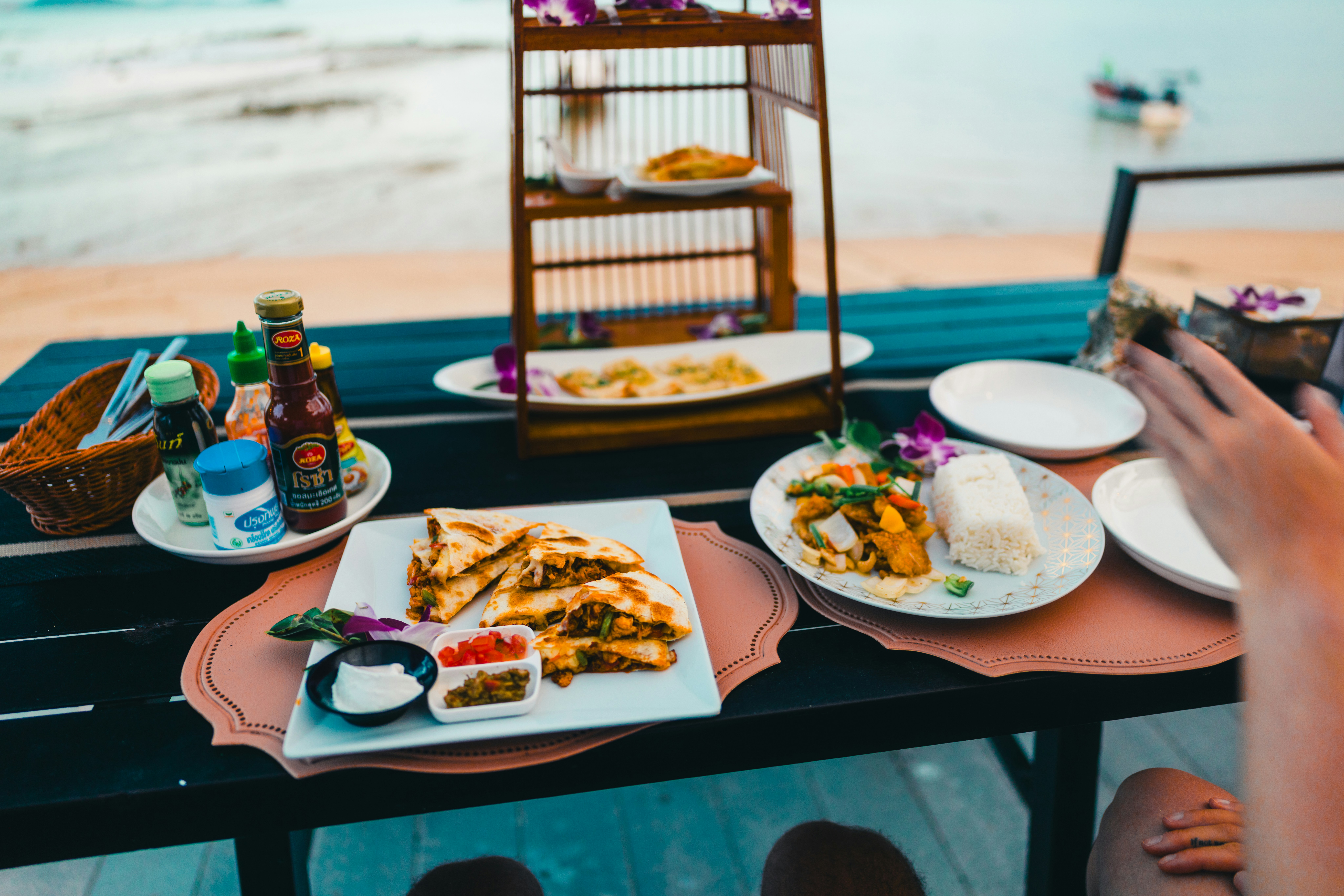 Food and drinks are set for a seaside meal.