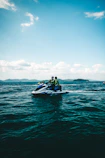 People are riding a jet ski on the ocean.