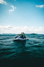 People are riding a jet ski on the ocean.